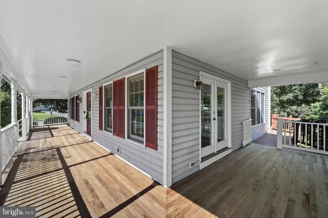 a view of staircase with white walls and door