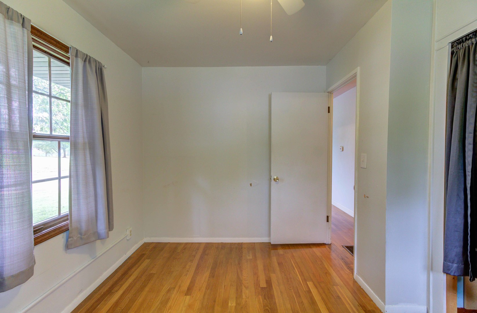1201 Eastern Drive Urbana, IL 61801 - Photo 14 of 30 a view of an empty room with wooden floor and a window