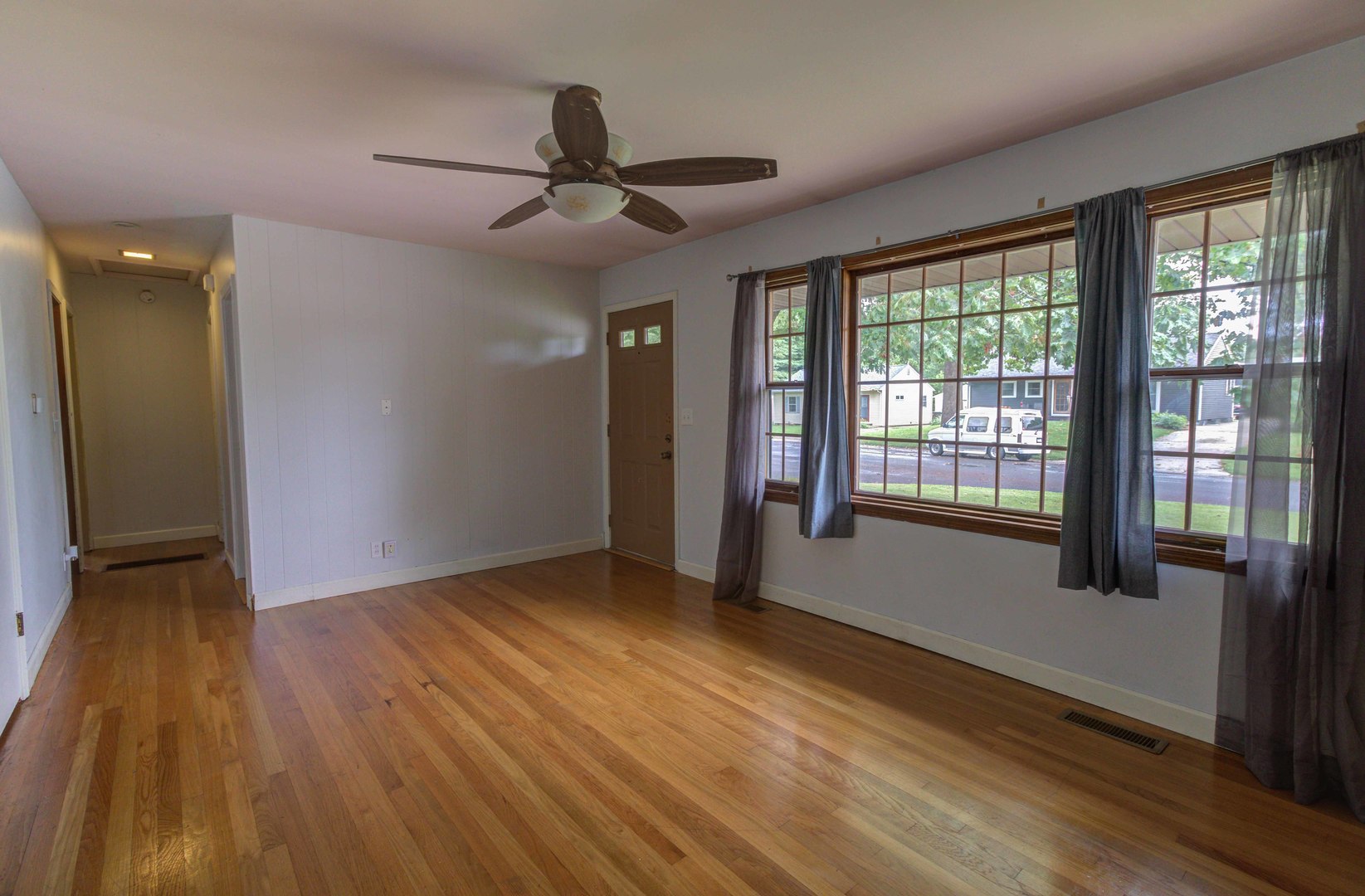 1201 Eastern Drive Urbana, IL 61801 - Photo 6 of 30 a view of an empty room with wooden floor and a window