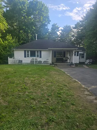 a house view with a sitting space and garden