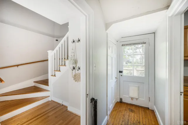 a view of entryway with wooden floor and stairs