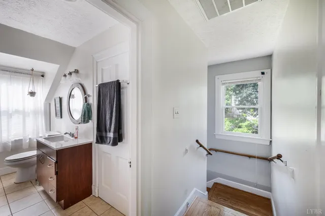 a bathroom with a toilet a sink and mirror