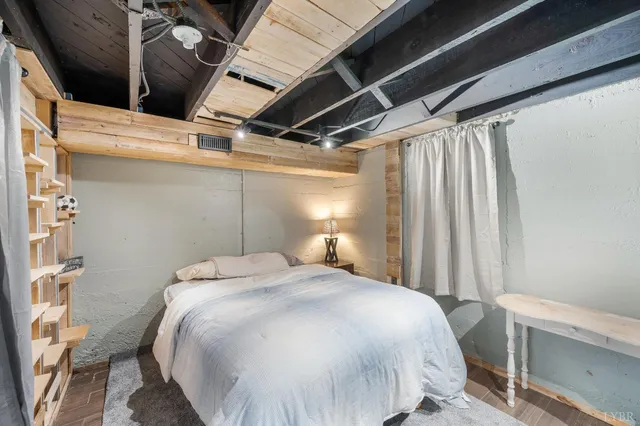 a large bed sitting in a bedroom next to a window