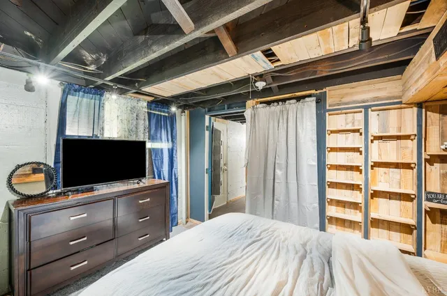 a bedroom with a bed and a flat screen tv