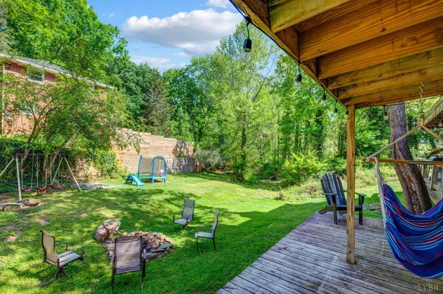a view of a backyard with table and chairs and a barbeque