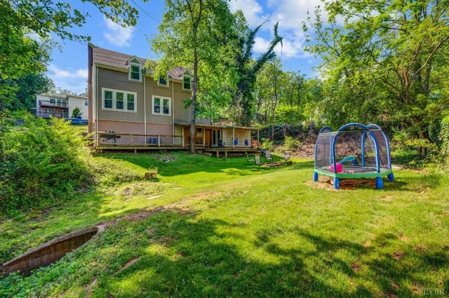 a view of a house with swimming pool and sitting area