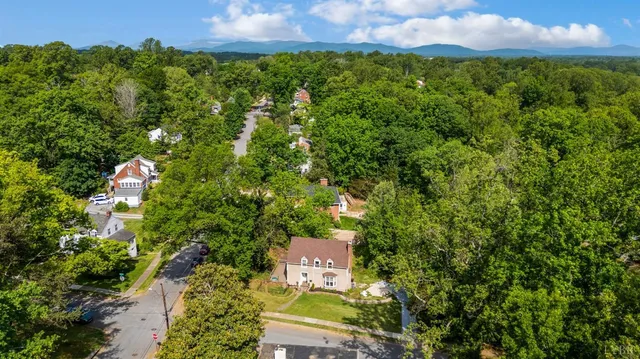 an aerial view of a house with a yard
