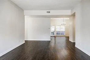 a view of a room with wooden floor and a window