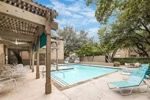 a view of a swimming pool with an outdoor seating