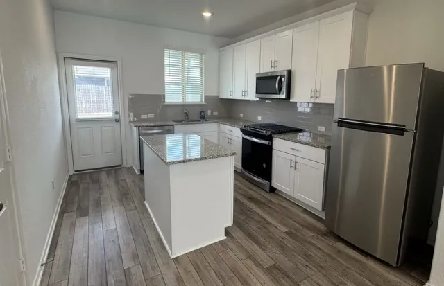 a kitchen with a refrigerator stove and sink