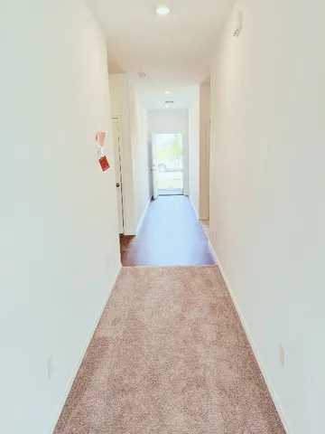 a view of a hallway to rooms