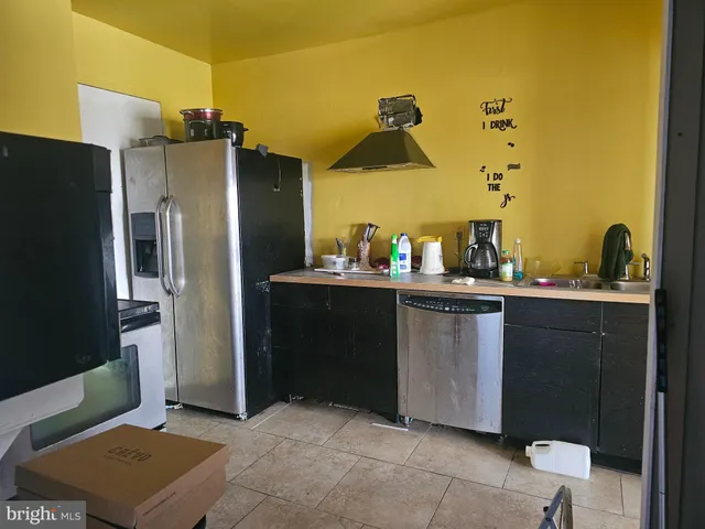 a kitchen with a sink and refrigerator