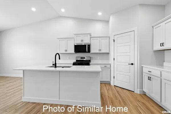 a kitchen with cabinets a sink and appliances