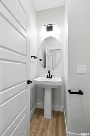 a bathroom with a sink toilet and a mirror