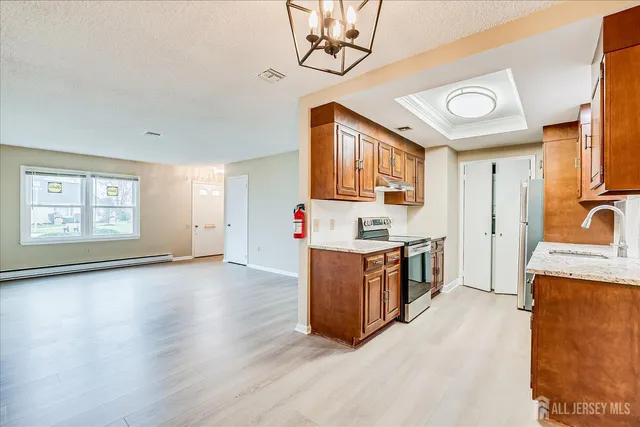 a kitchen with stainless steel appliances granite countertop a stove and a sink