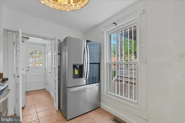 a view of a kitchen with an entryway and wooden floor