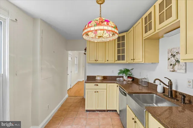 a kitchen with a sink cabinets and a window