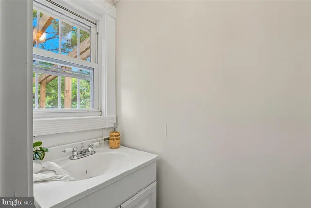 a bathroom with a sink and a window