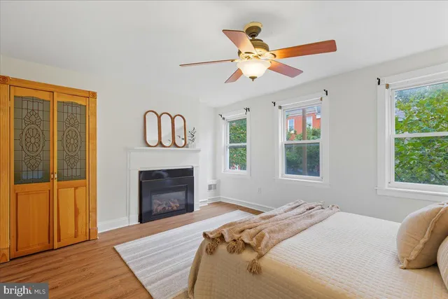 a bedroom with a bed and a fireplace