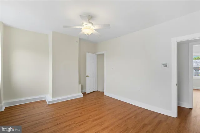 a view of a room with wooden floor