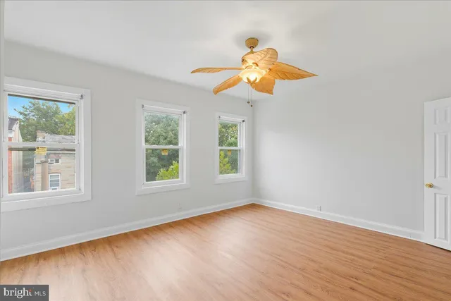 a view of an room with wooden floor and window