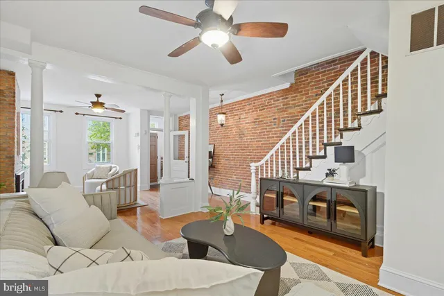 a living room with furniture and a stairs