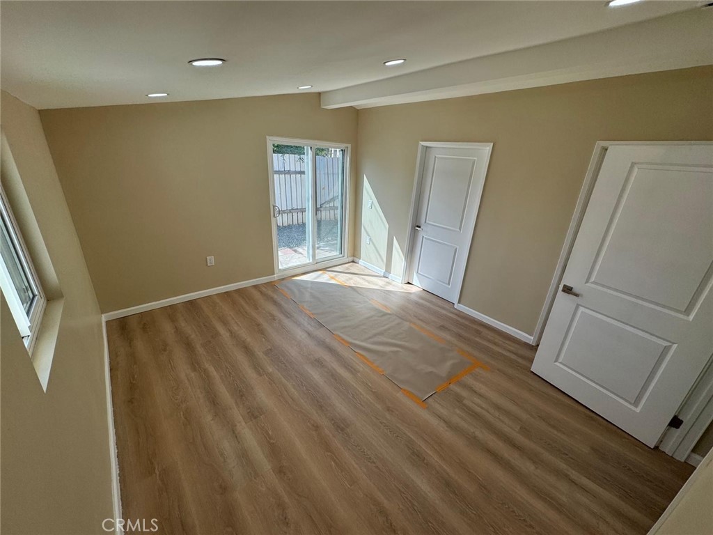 5276 Almar Street Riverside, CA 92505 - Photo 6 of 13 a view of empty room with wooden floor and fan