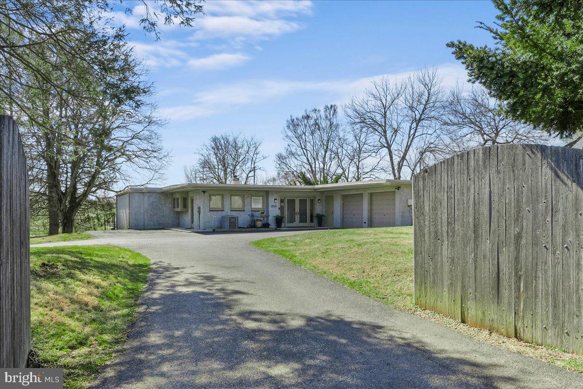 1056 Lenape Road West Chester, PA 19382 - Photo 1 of 48 a front view of a house with a yard and pathway
