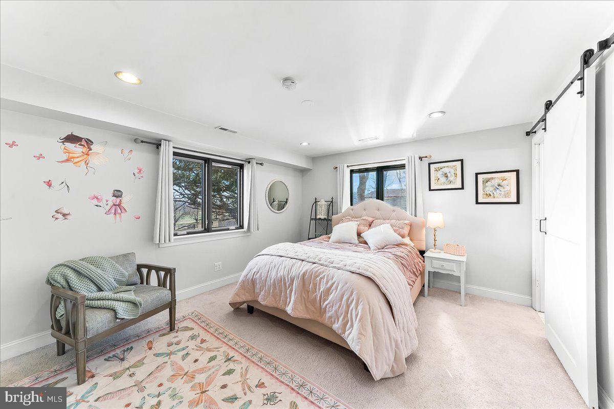 1056 Lenape Road West Chester, PA 19382 - Photo 26 of 48 a spacious bedroom with a bed and a couch