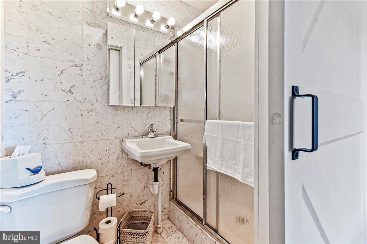 1056 Lenape Road West Chester, PA 19382 - Photo 29 of 48 a bathroom with a sink a toilet and shower