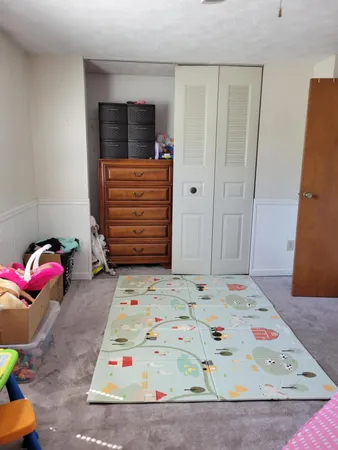 a bedroom with a bed and a dresser