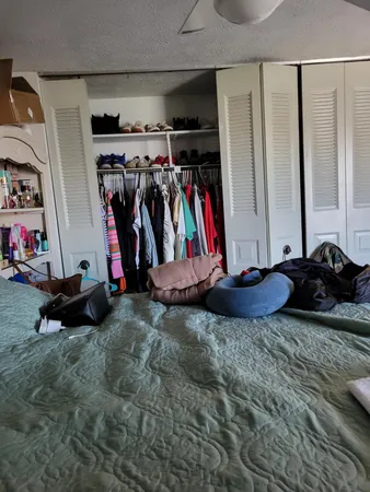 a view of walk in closet with clothes