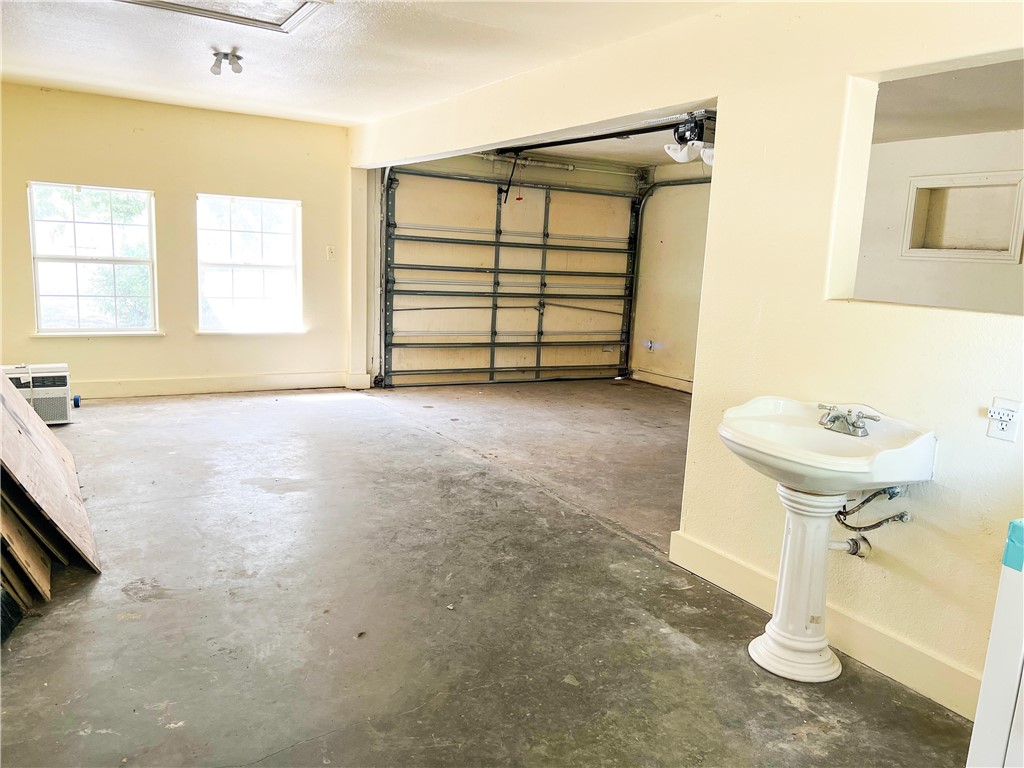 933 South Rife Street Aransas Pass, TX 78336 - Photo 14 of 17 a view of a room with a washing machine and mirrors