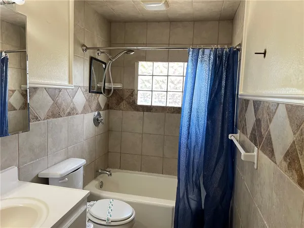 a bathroom with a toilet and a bath tub