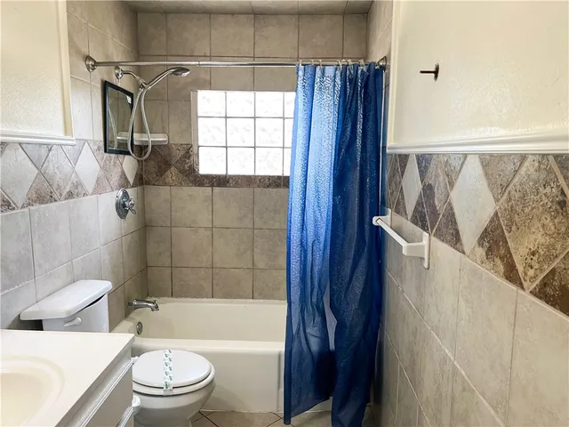 a bathroom with a toilet and shower