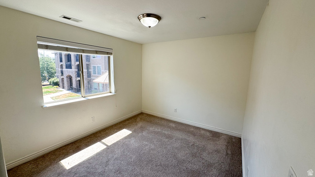 909 South Main Street, Unit F Layton, UT 84041 - Photo 8 of 21 Carpeted room with neutral painted walls and a single window