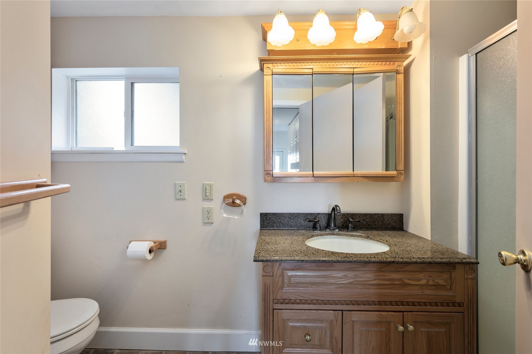 208 Reeds Lane Everson, WA 98247 - Photo 23 of 36 a bathroom with a granite countertop sink a toilet and a mirror