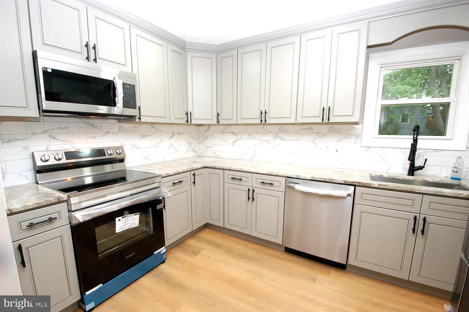 780 Stinchcomb Road Severna Park, MD 21146 - Photo 14 of 58 a kitchen with cabinets stainless steel appliances a sink and a window