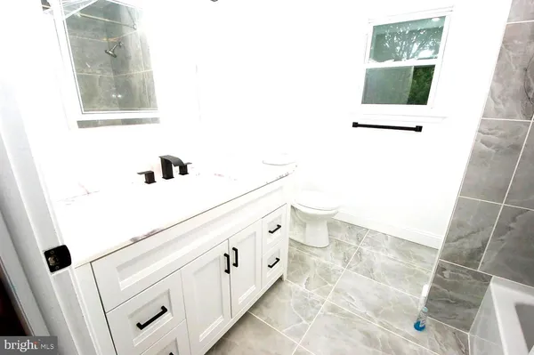 a bathroom with a double vanity sink and mirror