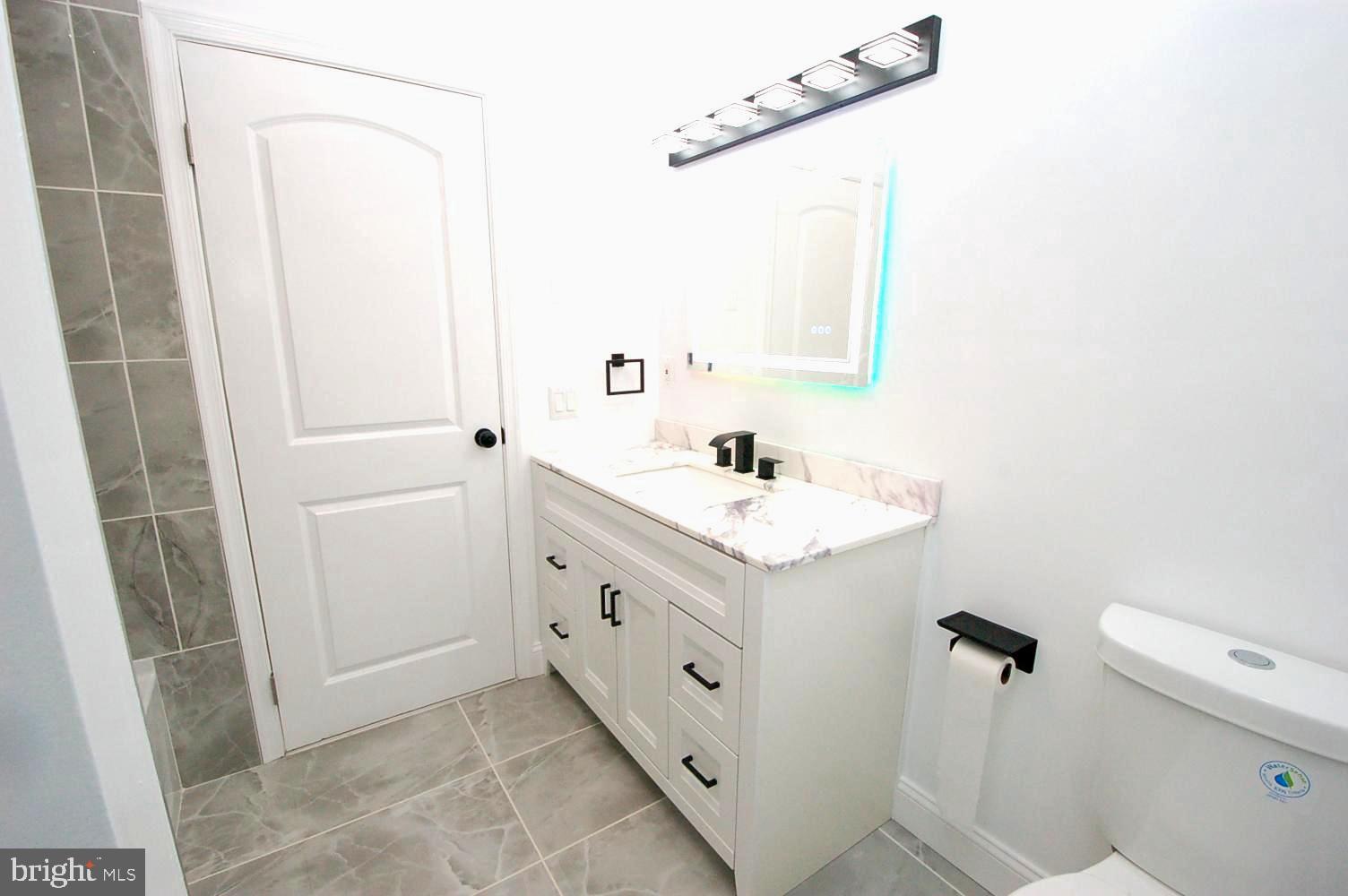 780 Stinchcomb Road Severna Park, MD 21146 - Photo 20 of 58 a bathroom with a double vanity sink and mirror