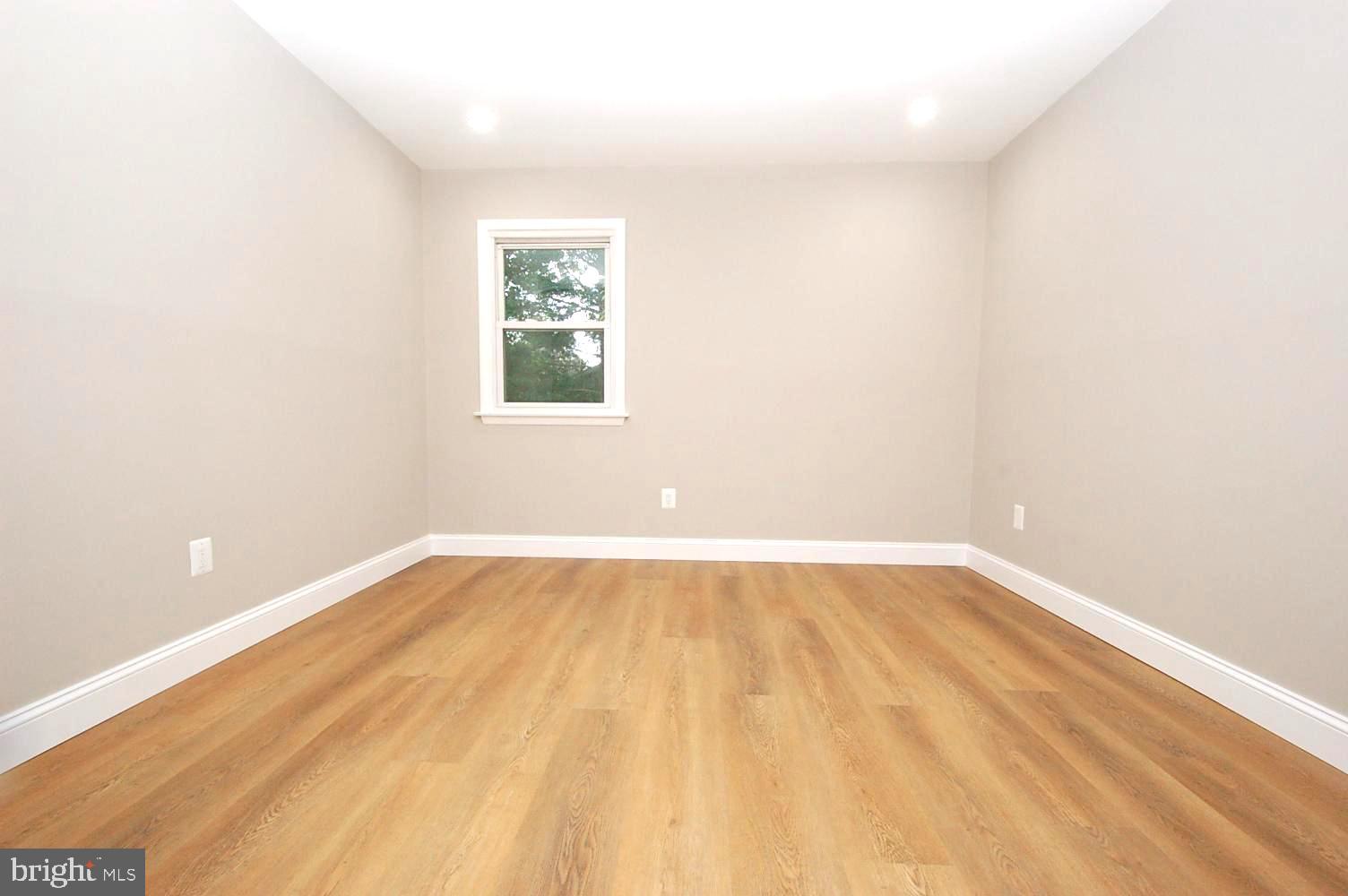 780 Stinchcomb Road Severna Park, MD 21146 - Photo 23 of 58 a view of an empty room with wooden floor and a window