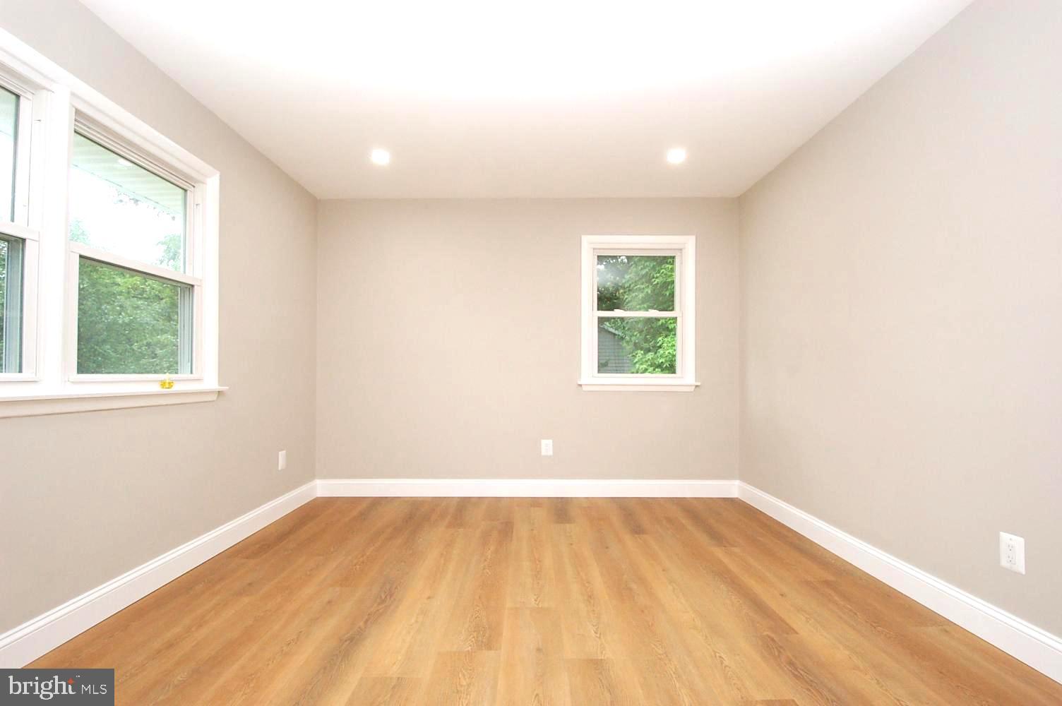 780 Stinchcomb Road Severna Park, MD 21146 - Photo 28 of 58 an empty room with wooden floor and windows