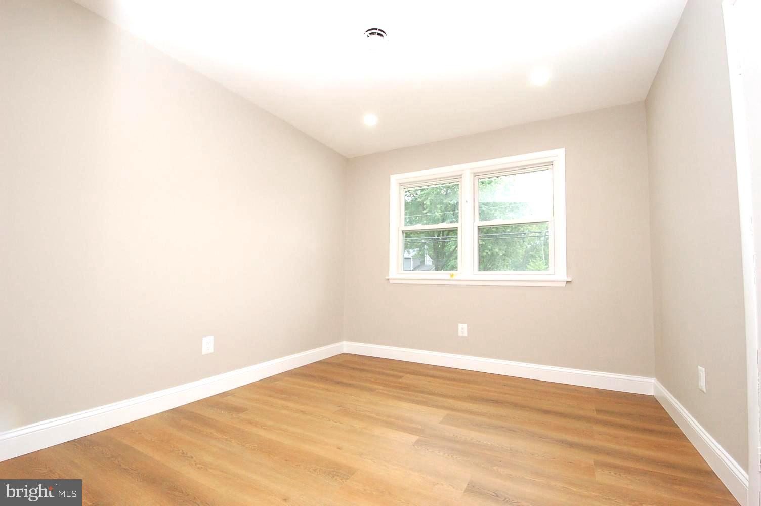 780 Stinchcomb Road Severna Park, MD 21146 - Photo 29 of 58 an empty room with wooden floor and windows