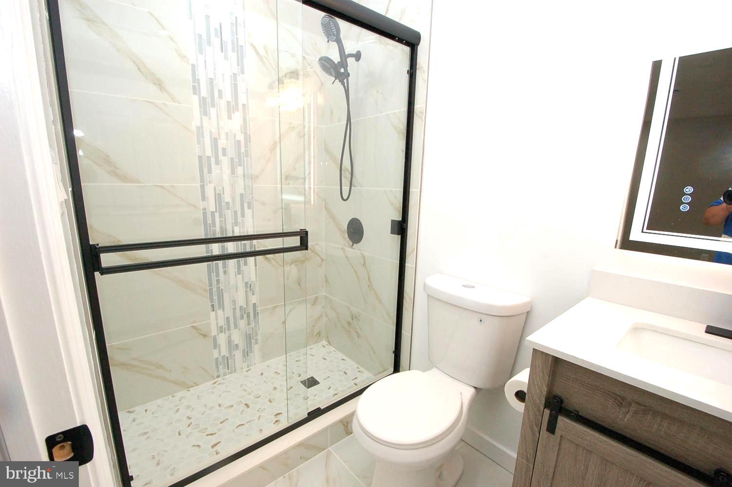 780 Stinchcomb Road Severna Park, MD 21146 - Photo 30 of 58 a bathroom with a shower a toilet and a sink