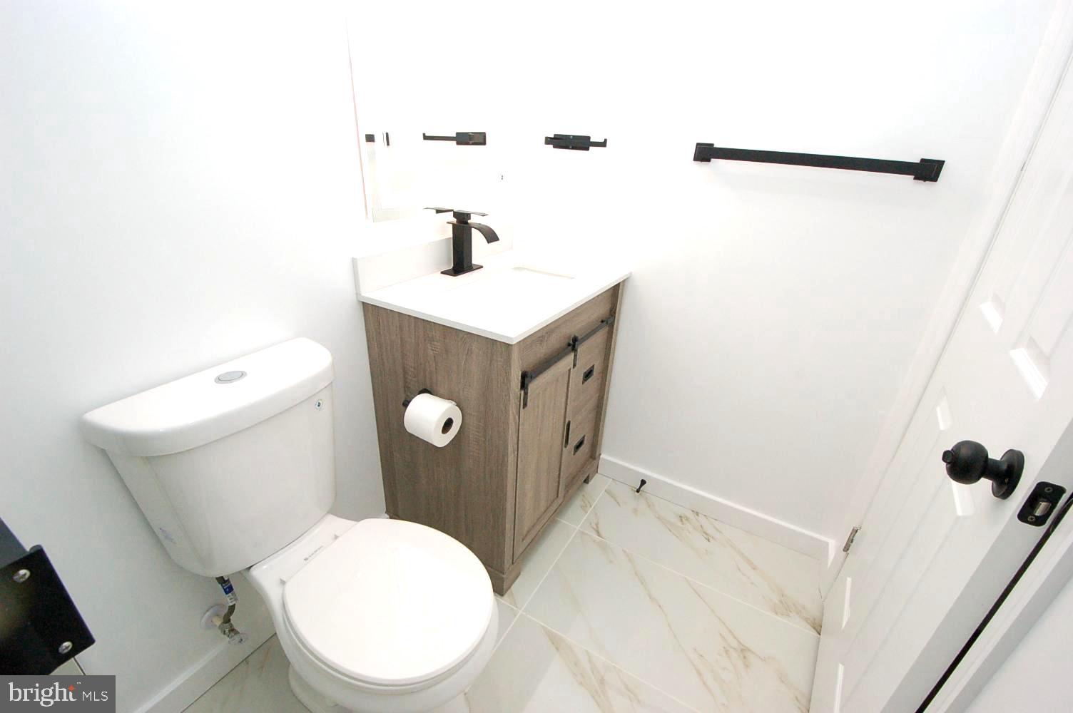 780 Stinchcomb Road Severna Park, MD 21146 - Photo 33 of 58 a white toilet sitting next to a bathroom sink