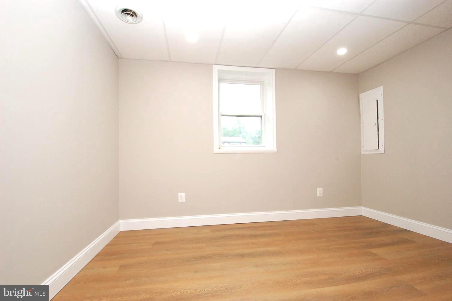 780 Stinchcomb Road Severna Park, MD 21146 - Photo 34 of 58 an empty room with wooden floor and windows