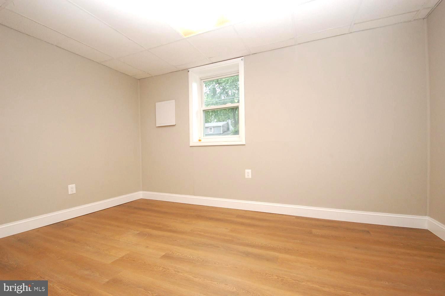 780 Stinchcomb Road Severna Park, MD 21146 - Photo 35 of 58 an empty room with wooden floor and windows
