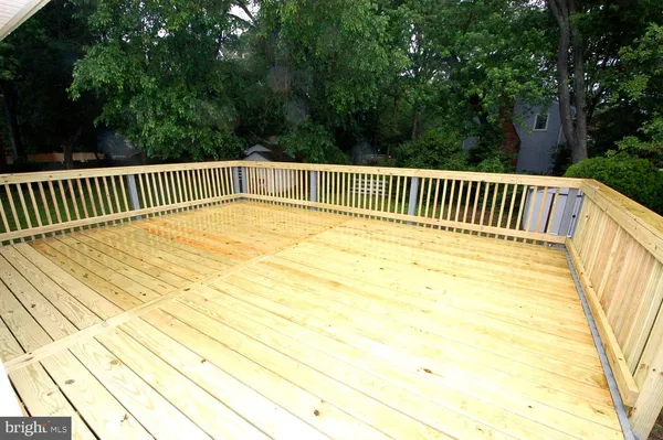 a view of balcony with wooden floor and fence