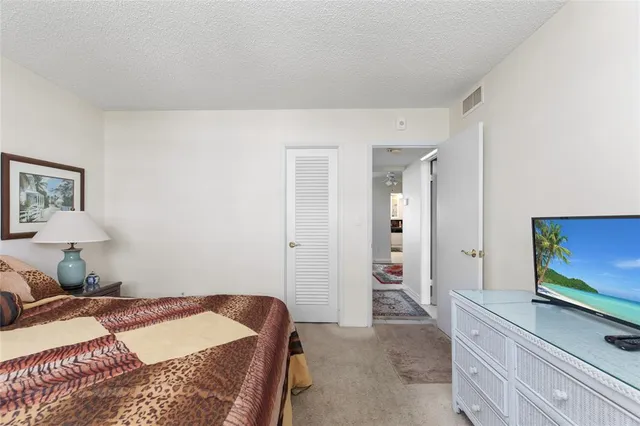 a kitchen with granite countertop a sink a stove and cabinets
