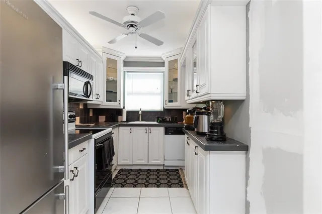 a living room with furniture floor to ceiling window and a flat screen tv